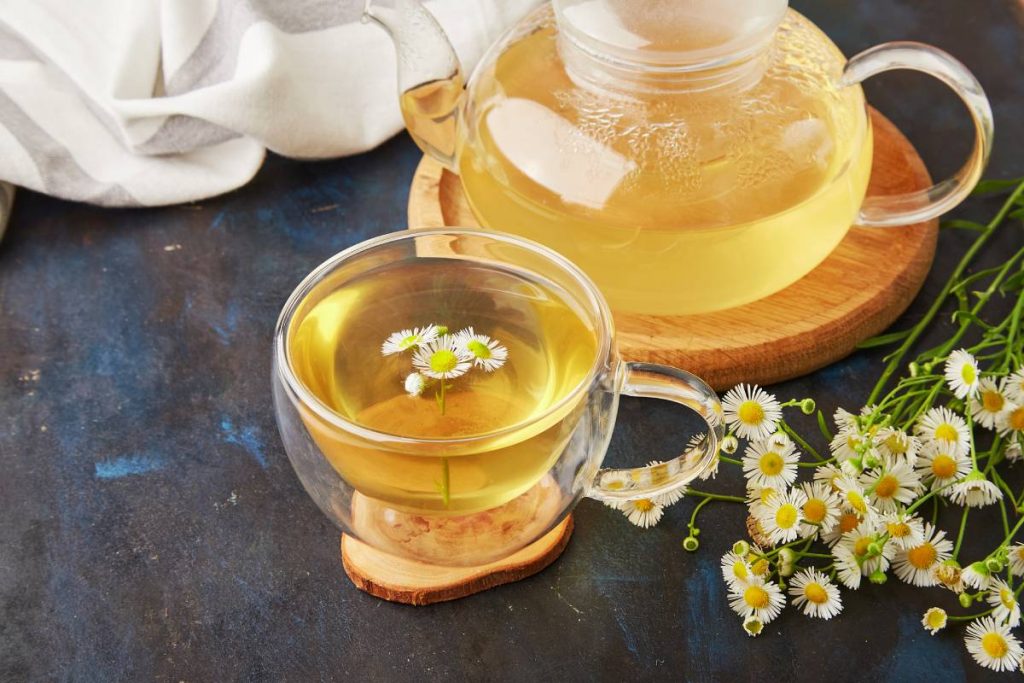 Aesthetic organic herbal chamomile tea. Summer table setting, natural healthy beverage
