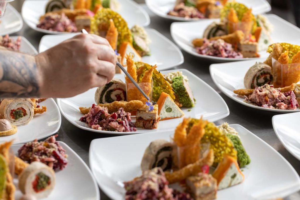 Chef decorating a dish in restaurant kitchen counter