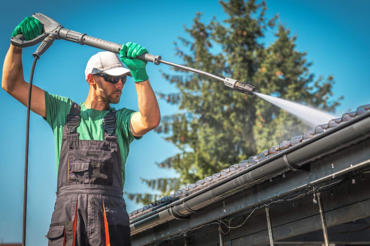 Washing Plastic Transparent Carport Roof by Caucasian Men. Pressure Washer Job.