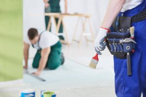 Group of specialists working by the house renovation together